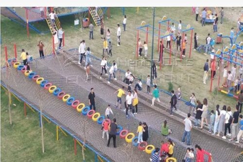 Amusement park tire and swing bridge combination